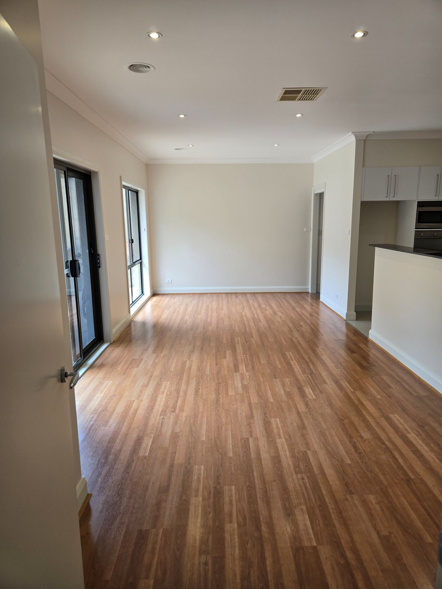 Bright, freshly painted open-plan living and kitchen area
