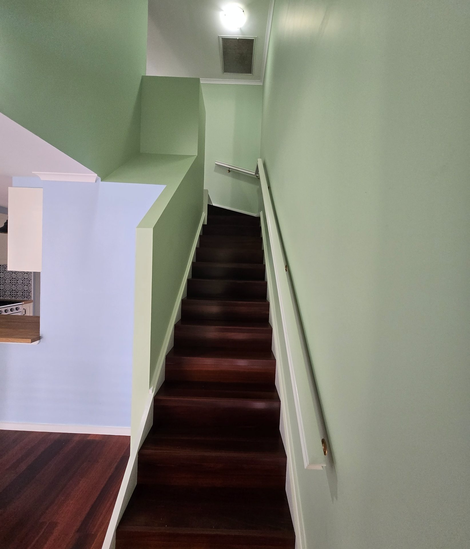 Freshly painted green stairwell in a Canberra home